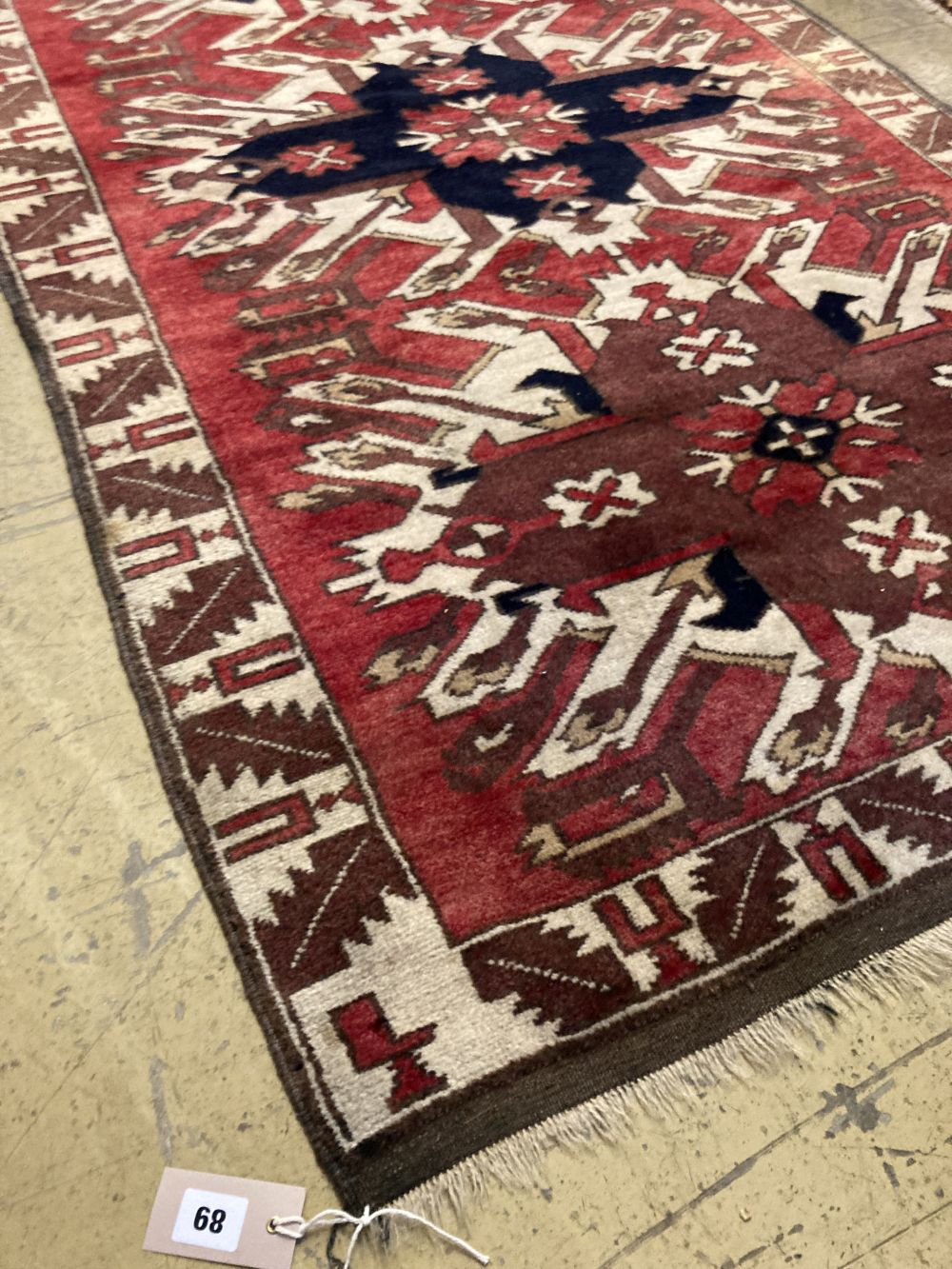 A Kazak red ground rug, 180 x 105cm